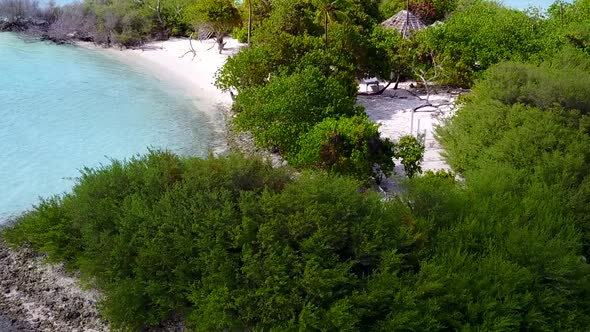 Sunny scenery of exotic tourist beach break by blue water with sand background in sunlight