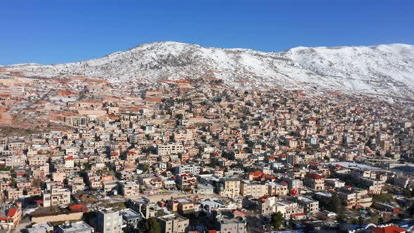 Hermon mountain ridge covered with snow during 2022 winter, with the town houses of Majd al Shams.