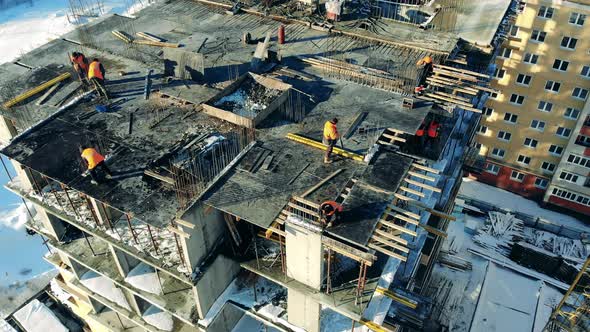 A Group of Workers on Top of a Building Under Construction alt