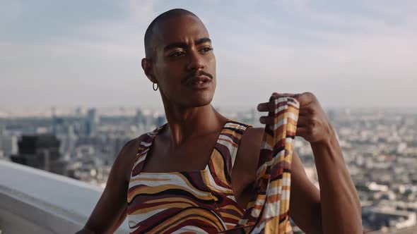 Model In High Fashion Leaning Against Balustrade Over City