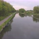 Aerial Footage Traveling Along a Canal Bordered By Trees - VideoHive Item for Sale
