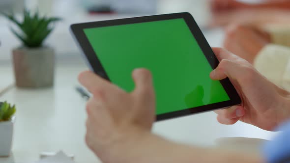 Male Hands Touching Green Screen Tablet Indoors