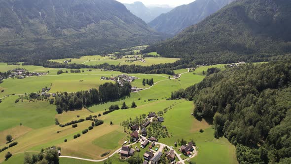 Aerial view of the village, fields and forest in mountains Alps Austria