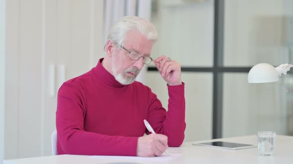 Old Man Writing on Paper Thinking