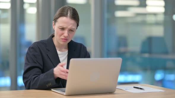 Beautiful Young Businesswoman Reacting to Loss While using Laptop