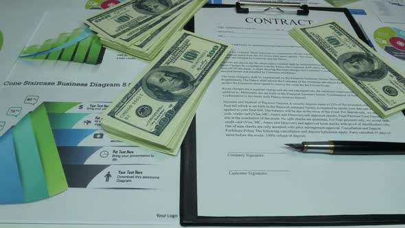 Financial Business Contract And Dollars On The Table In The Office Of The Company