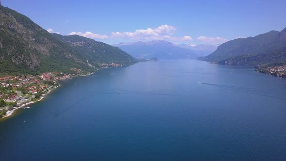 Aerial view drone flies over beautiful mountain lake Como in Italy, sunny weather