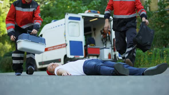 Ambulance Service Staff Care for Patient on Road, Putting Intravenous Equipment