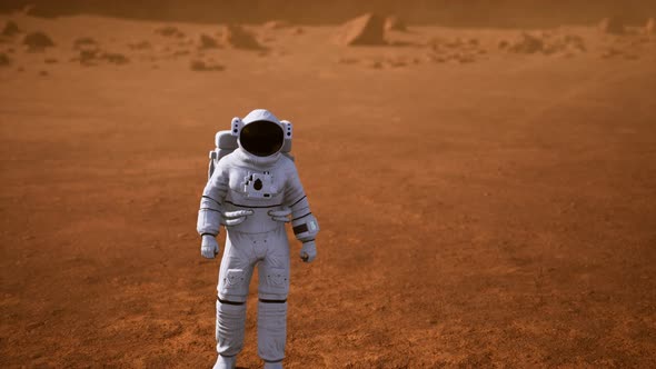 Astronaut on Mars Surface. Red Planet Covered in Gas and Rock