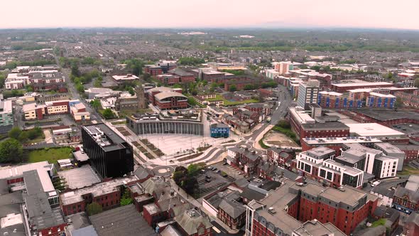 Reverse aerial view of University of Central Lancashire and Adelphi in Preston on a cloudy day