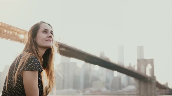 Happy Smiling European Young Woman Smiling, Enjoying Amazing Sunset View of New York Near Brooklyn