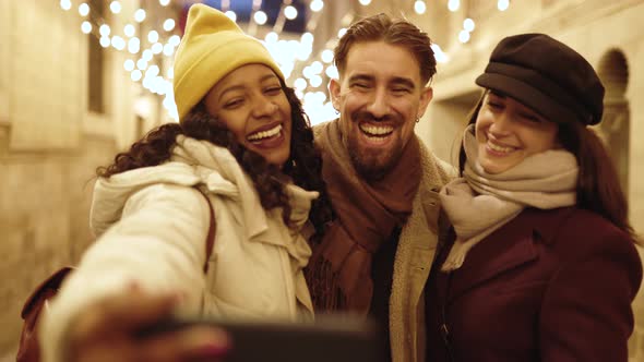 Happy Multiracial Friends Taking Selfie with Mobile Phone on Winter Holidays