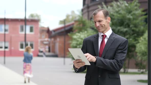 Businessman Browsing Internet on Tablet