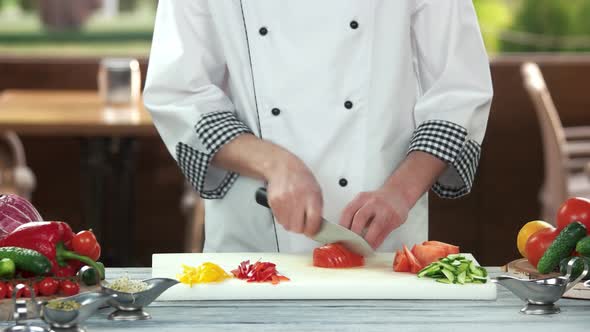 Chef Cutting Tomato.