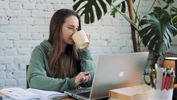 Serious White Girl Student Typing on Laptop Preparing Course Work