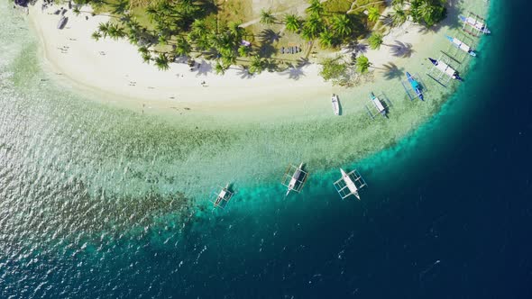 Boats Moored at Paradise Tropical Ipil Beach on Pinagbuyutan Island with Azure Turquoise Sea in El