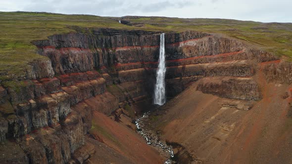 Aerial Static Footage of Hengifoss Waterfall Red Canyon and Mountain River in Iceland