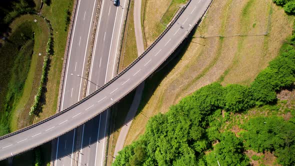 Aerial top down shot of cars on freeway in Poland with exit bridge during sunny day,4k
