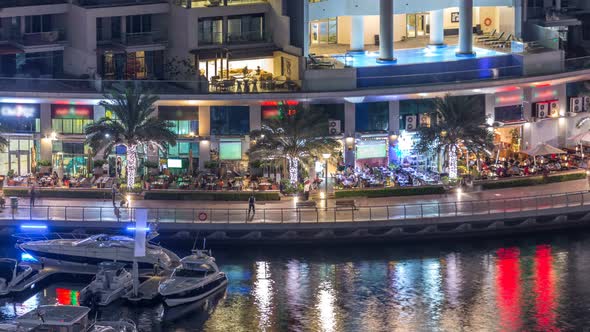 Luxury Dubai Marina Canal with Passing Boats and Promenade Night Timelapse Dubai United Arab