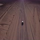 Car Driving on Gravel Road in Aerial Desert - VideoHive Item for Sale