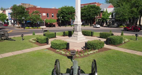 Antique American Civil War cannon with drone video moving up to confederate soldier statue in downto