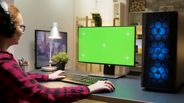 Woman with Headphones Playing Games on Computer in Living Room