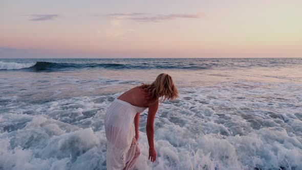 Attractive Woman Enjoying The Beach At Sunset