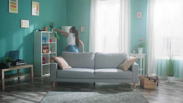 Woman Is Dancing and Cleaning Living Room