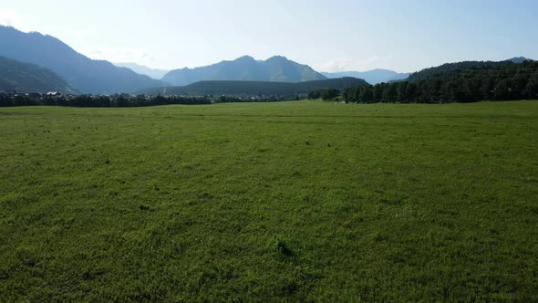 In the Distance you Can See a Small Village Against the Background of High Mountains