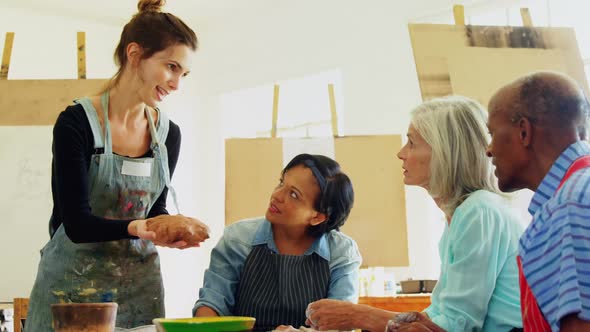 Woman assisting artists in pottery 4k