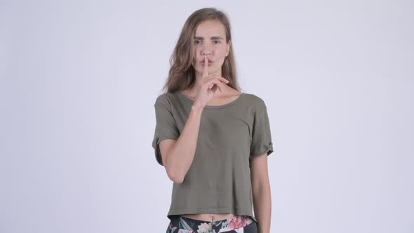 Young Serious Woman with Finger on Lips