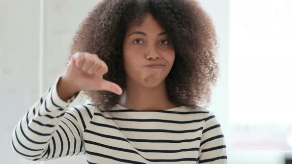 African Woman Doing Thumbs Down 