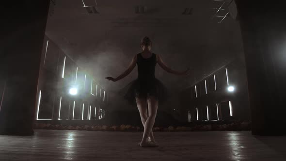 Slow Motion Prima Ballet on Stage Rehearsing Performance in the Dark Light of the Contra