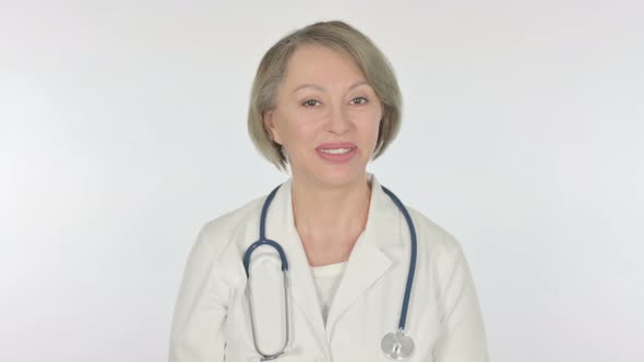 Old Female Doctor Talking on Online Video Call on White Background