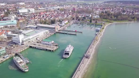 Aerial Shot Of Ferry Arriving At Port In Friedrichshafen. Lake Of Constance.