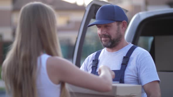 Worker of Delivery Service Giving Box To Woman