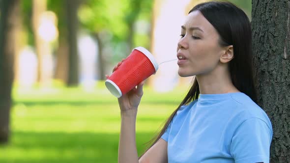 Girl Drinking Cocktail in Plastic Cup, Throwing Trash on Grass, Littering