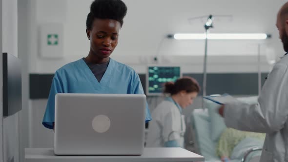 Afro American Assistant Typing Sickness Symptom on Computer