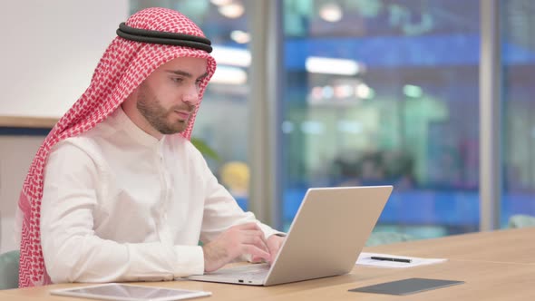 Serious Arab Businessman Working on Laptop in Office 