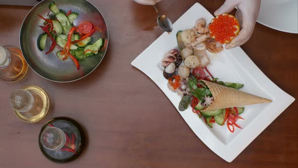 Decorating Fresh Vegetables Salad with Caviar