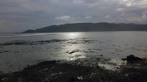 Sun sky clouds reflected in water. Dramatic aerial view flight panorama overview drone footage of Ma