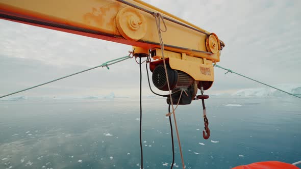 Hook And Crane On Boat Sailing Calm Sea Just Off Coast Of Greenland