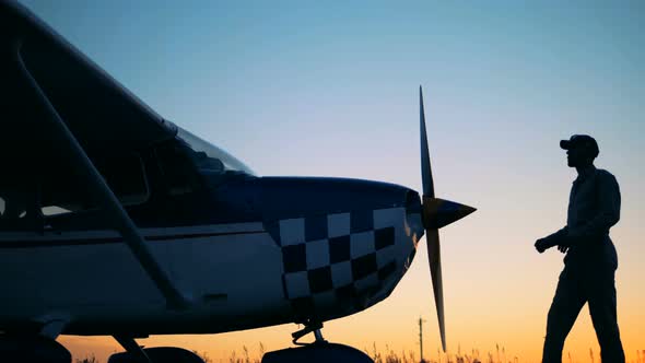 A Pilot Leaning on a Biplane's Propeller. Portrait of a Female Pilot.