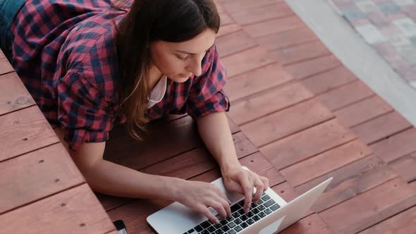 Girl Working at a Laptop in the Fresh Air