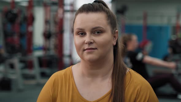 Portrait of smiling caucasian woman with overweight at the gym. Shot with RED helium camera in 4K.