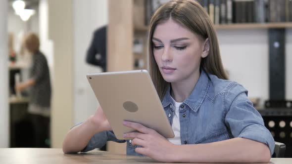 Young Woman Browsing Internet on Tablet