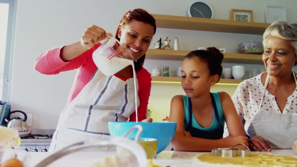 Happy multi-generation family preparing cookies in kitchen 4k