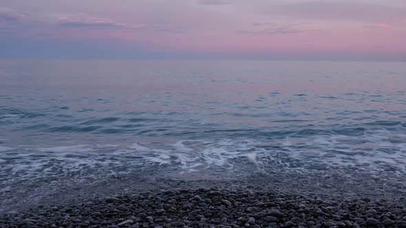 Rocky beach in dusk hour. 