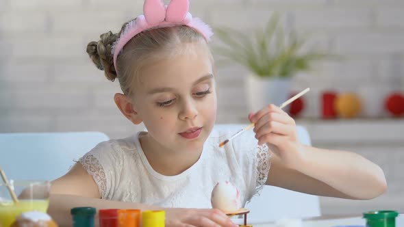 Little Girl in Cute Headband Coloring Egg With Bright Paint, Art School for Kids