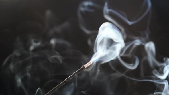 Smoke From an Aromatic Stick on a Black Background alt